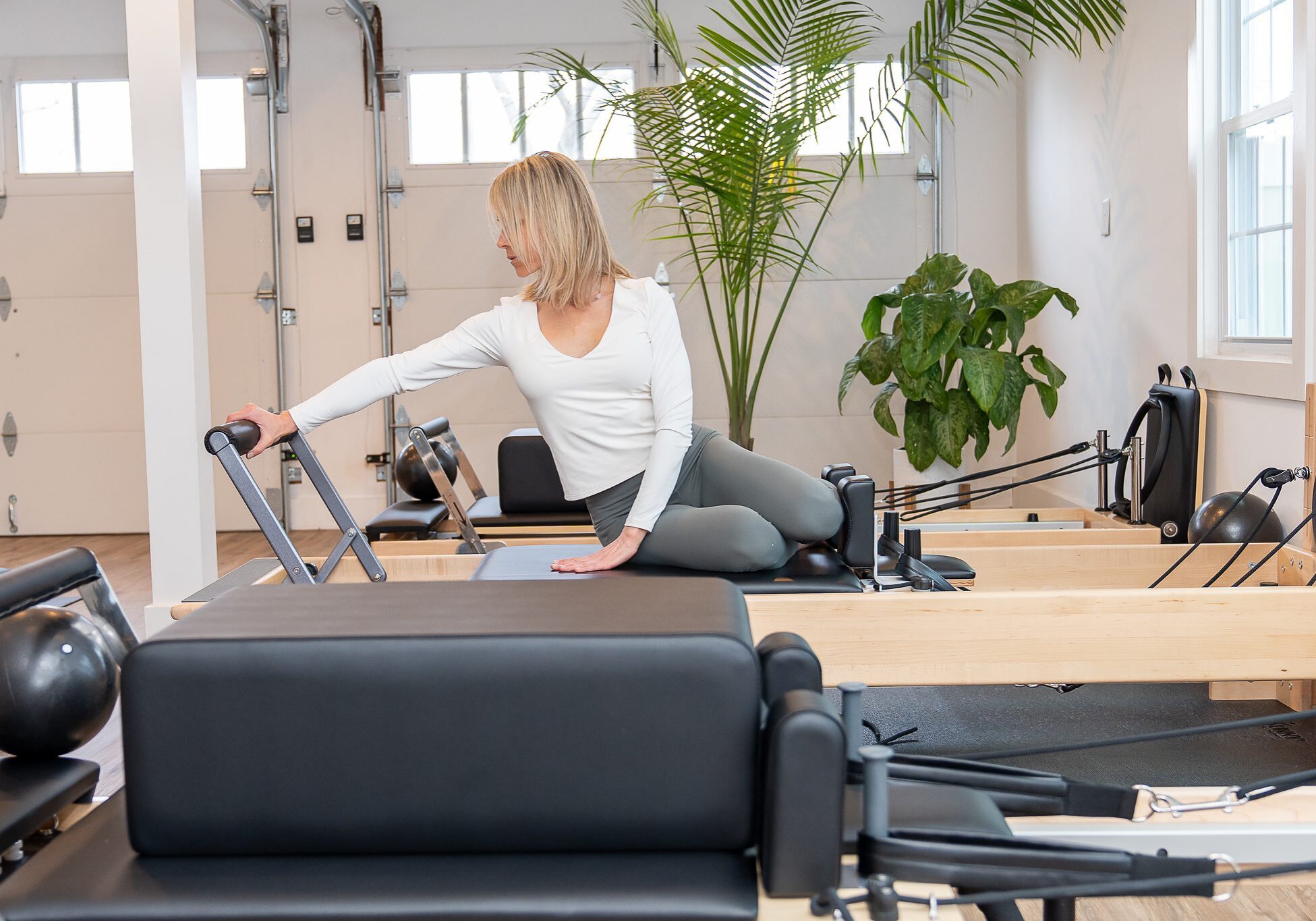 Woman practicing on Pilates reformer machine