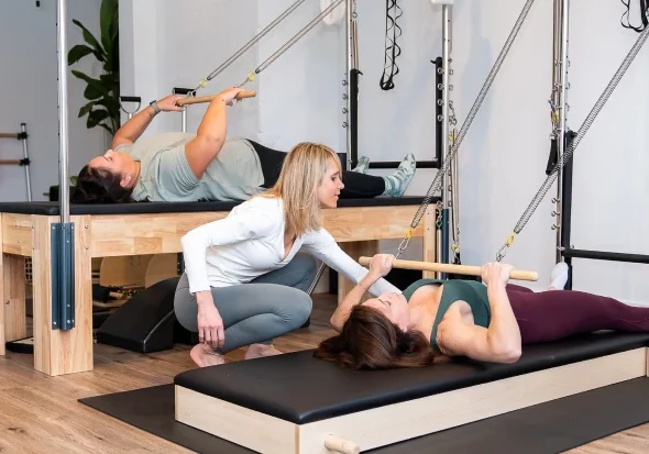 Fitness session with Pilates equipment and instructor